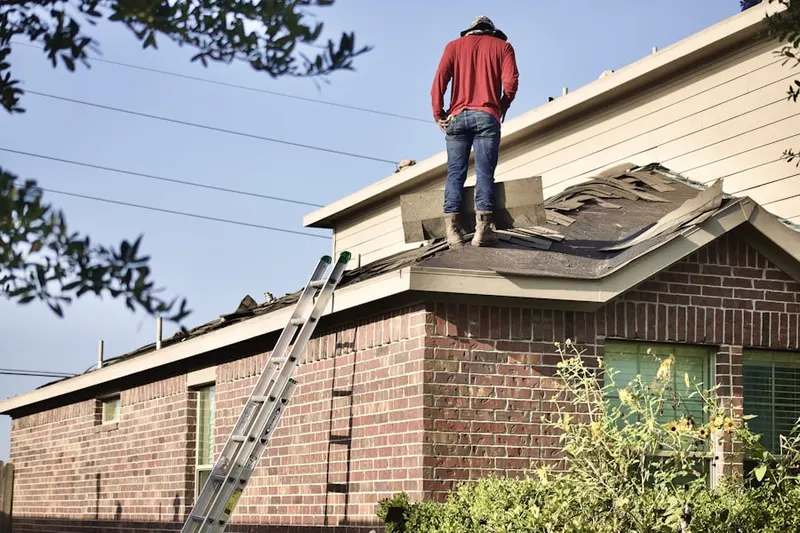 Professional roofer working on a residential roof in Aberdeen Proving Ground
